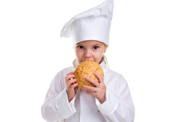 Chef girl in a cap cook uniform, holding and smelling the bread with sesame. Looking at the camera