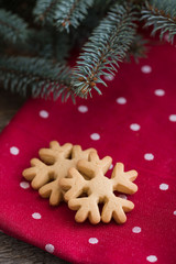 A pile of gingerbread Christmas cookies on red polka dot towel