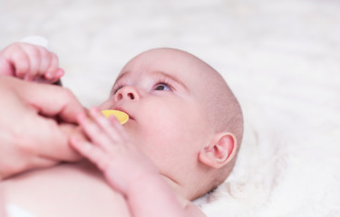 A very small child, a baby at the doctor's office and he is given a medicine for coughing and...