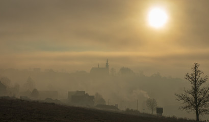 Naklejka premium misty sunrise over the church in Jablonce, Poland