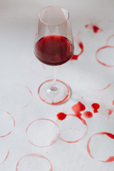 Traces of wine near glass of beverage on white background . Wine degustation concept