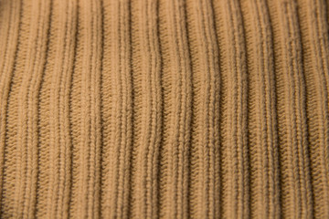 texture of knitted stripes of beige yarn