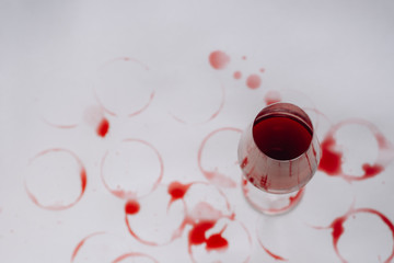 Traces of wine near glass of beverage on white background . Wine degustation concept