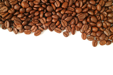Top view of heap of roasted coffee beans isolated on white background with free space for text or design 