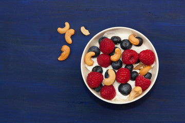 Raspberries, blueberries and cashew nuts with greek yogurt.