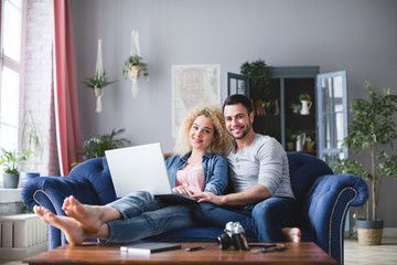 Happy family with laptop at home.