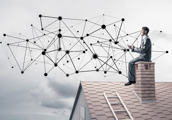 Man on roof with smartphone and concept of social connection