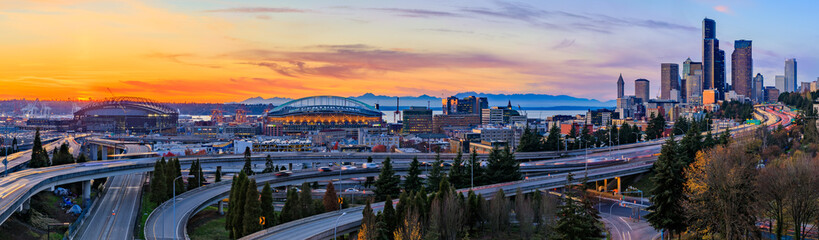 Seattle downtown skyline panorama at sunset from Dr. Jose Rizal or 12th Avenue South Bridge with traffic trail lights - obrazy, fototapety, plakaty