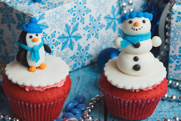 Christmas cupcakes with colored decorations, soft focus background