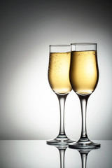 Two elegant glasses with sparkling champagne