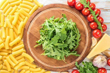 Ingredients for cooking pasta with a kitchen board for copy space