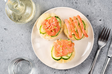 Bruschetta toast of white bread with slices of pineapple cucumber fish salmon fresh green sprouts