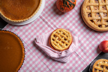 Mini apple pie surrounded by various pies. Above view. Sweet pastry.
