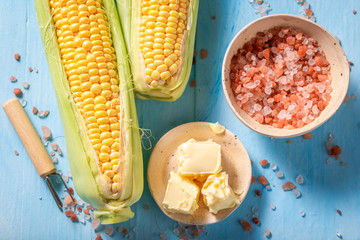 Preparations for grilling sweet corncob with salt and butter