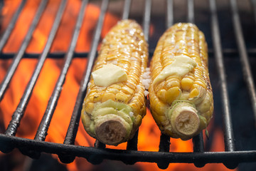 Fresh and healthy corncob on grill with butter and salt