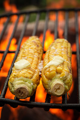 Sweet and salty corncob on grill with salt and butter