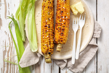 Fresh and healthy corn from grill with salt and butter