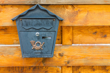 A beautiful mailbox hangs waiting for newspapers, parcels and letters.