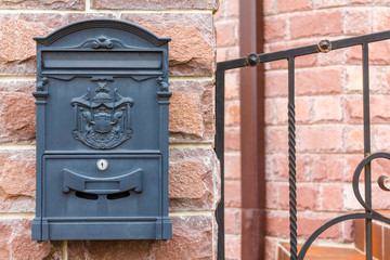 A beautiful mailbox hangs waiting for newspapers, parcels and letters.