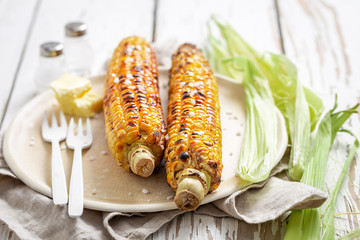 Hot and delicious corn from grill with salt and butter