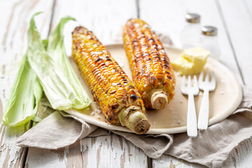 Tasty and homemade corn from grill with butter and salt