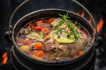 Hot and yummy hunter's stew on campfire