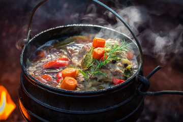 Delicious and fresh hunter's stew on bonfire