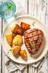 Fresh steak and roasted potatoes with salt and thyme