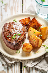 Tasty steak and roasted potatoes with salt and thyme