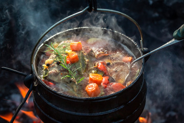 Hot and yummy hunter's stew on bonfire