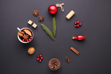 A clock in the form of spice for mulled wine. Cinnamon, anise stars, cranberries, brown sugar. Concept, creative work.