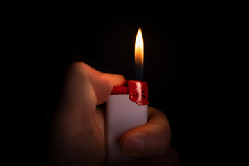 hand with a lighter burning flame 
