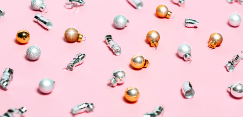 Christmas background with golden decorations put as frame on pink pink background. Bright and festive flat lay. Top view, Copyspace for text. Greetings for christmas or new year.