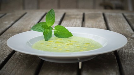 Green vegetable soup on a wooden table