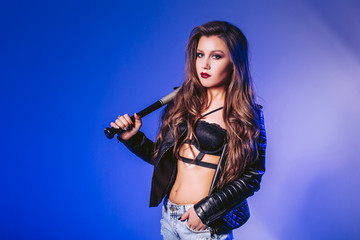 Sexy girl holding a baseball bat in her hand