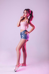 Naklejka premium Beautiful woman in studio on a light purple background