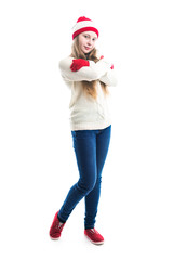 Happiness winter holidays christmas. Teenager concept - smiling young woman in red hat, scarf and over white background.
