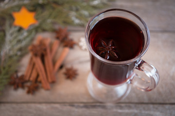 mulled wine with spices on wooden background