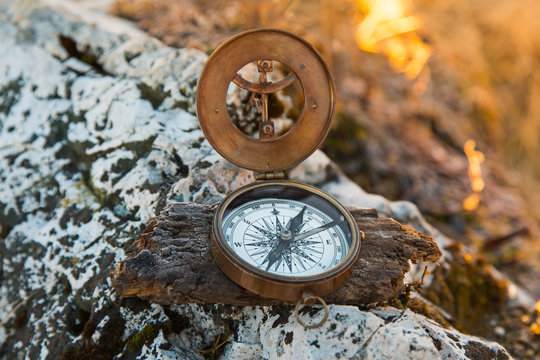 Retro analogic compass on the mountains rocks.