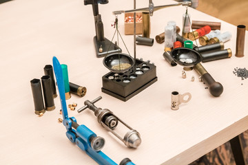 shotgun cartridges reloading. capsules, shells, powder, cartridges, scales on the table