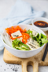 Vegan bun cha salad bowl. Vietnamese rice noodle with tofu and chilli vegetables salad in white bowl.