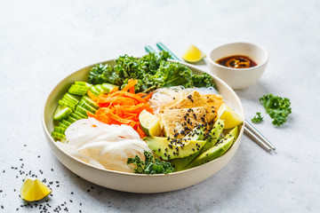 Vietnamese rice noodle with grilled tofu and  chilli vegetables salad in white bowl, copy space.