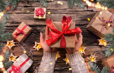 Top view of woman hands with gift box.
