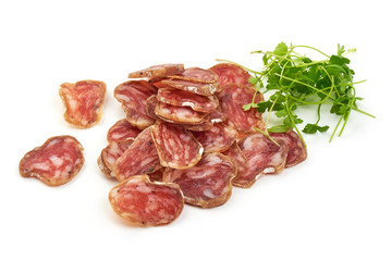 Thin Sliced Jerked Sausage from pork with parsley, isolated on a white background. Close-up