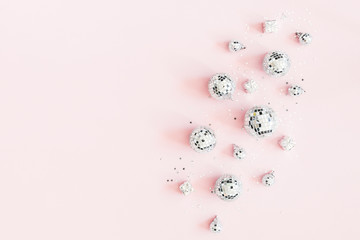 Christmas composition. Silver disco balls on pastel pink background. Christmas, winter, new year...