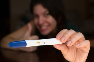 Excited Woman Showing Off Her Pregnancy Test