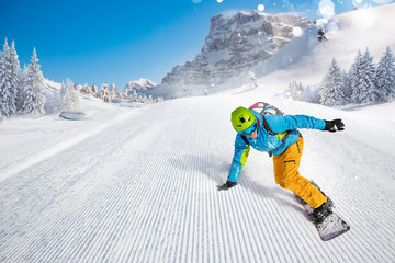 Man snowboarder riding on slope.