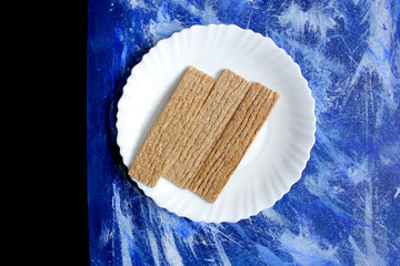 three slices of crispy bread on a blue background