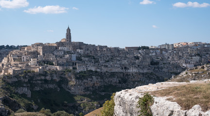 Houses built into the rock in the cave city of Matera, Basilicata Italy. Matera has been designated European Capital of Culture for 2019. Photographed from inside a cave in the ravine opposite.
