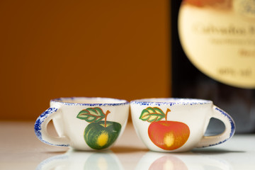 Two small cups with painted apples for drinking apple brandy
